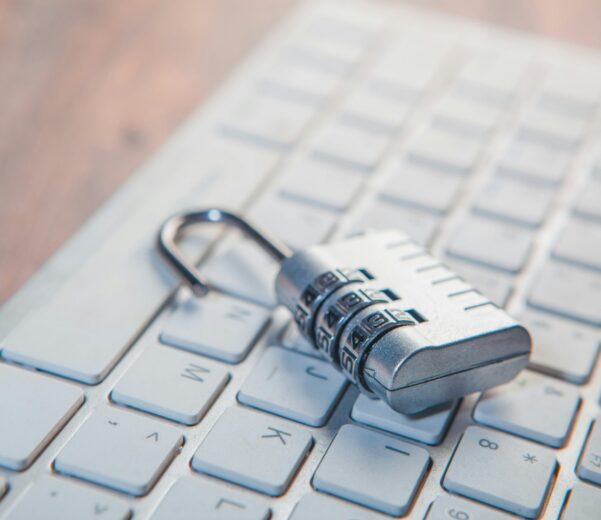 A combination lock rests on a computer keyboard